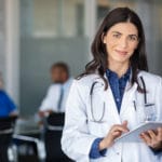 Doctor holding digital tablet at meeting room